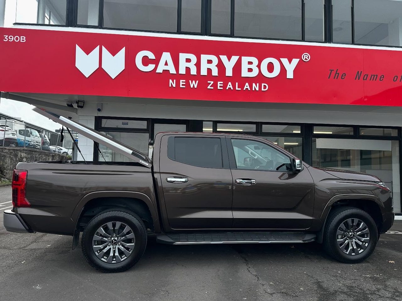 Brown Mitsubishi Triton with the Sport Lid SV open outside CARRYBOY New Zealand